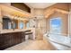 Bright bathroom with soaking tub, glass shower, and double sink vanity at 12555 Critchell Ln, Littleton, CO 80127
