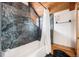 Rustic bathroom with gray stone tiles in shower with a wooden bench at 12555 Critchell Ln, Littleton, CO 80127