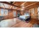 Log walled bedroom featuring hardwood floors, natural light, and cabin-style decor at 12555 Critchell Ln, Littleton, CO 80127