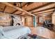 Rustic log cabin bedroom with a stone fireplace, wood floors, and a cozy atmosphere at 12555 Critchell Ln, Littleton, CO 80127