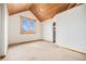 Cozy bedroom featuring wood-paneled vaulted ceilings and a built-in shelving unit at 12555 Critchell Ln, Littleton, CO 80127