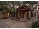 Inviting front entrance with stone accents, wooden beams, and a well-manicured landscape at 12555 Critchell Ln, Littleton, CO 80127