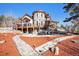 Beautiful home showcasing a stone turret, a large deck, manicured landscaping, and inviting outdoor spaces at 12555 Critchell Ln, Littleton, CO 80127
