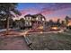 Picturesque home at twilight, featuring stone accents, inviting outdoor spaces, and subtle landscape lighting at 12555 Critchell Ln, Littleton, CO 80127