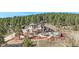 Stunning home with a stone exterior, multiple decks and outdoor entertainment areas, set amidst a lush, wooded landscape at 12555 Critchell Ln, Littleton, CO 80127