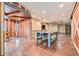 Spacious game room with pool table, concrete floors, and wood-paneled walls at 12555 Critchell Ln, Littleton, CO 80127