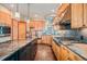 Spacious kitchen featuring a large island, custom wood cabinets, and stainless steel appliances at 12555 Critchell Ln, Littleton, CO 80127