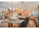 Spacious open concept kitchen with an island, pendant lighting, stainless steel appliances, and custom wood cabinetry at 12555 Critchell Ln, Littleton, CO 80127