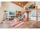 A spacious living room with high ceilings, wooden beams, and an open floor plan design at 12555 Critchell Ln, Littleton, CO 80127