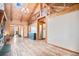 Open-concept living area with hardwood floors, natural light, and access to other rooms at 12555 Critchell Ln, Littleton, CO 80127