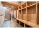 Mudroom with wooden lockers, bench and stone-tiled floor at 12555 Critchell Ln, Littleton, CO 80127