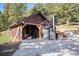 Rustic outbuilding featuring a wood-burning furnace, ideal for storage, and potential workshop space at 12555 Critchell Ln, Littleton, CO 80127