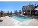 Sparkling in-ground pool with a cascading waterfall and a view, perfect for enjoying a peaceful outdoor retreat at 12555 Critchell Ln, Littleton, CO 80127