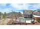 Inviting backyard with a refreshing pool, hot tub, outdoor seating, and lovely views of the surrounding wooded landscape at 12555 Critchell Ln, Littleton, CO 80127