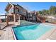 In-ground pool features stone accents and a waterfall, complemented by the adjacent outdoor space for lounging at 12555 Critchell Ln, Littleton, CO 80127