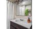 Bathroom featuring white sink, dark wood vanity, and modern mirror at 3764 N Raleigh St, Denver, CO 80212