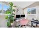 Bright office with a pink chair, desk, large plant, and lots of natural light at 3764 N Raleigh St, Denver, CO 80212