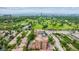 Aerial view showcases a brick condo building close to a golf course and road with beautiful green landscaping at 2400 E Cherry Creek South Dr # 207, Denver, CO 80209