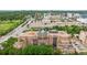 Exterior shot of condo with balconies, a unique roof top design, and green landscaping with city views at 2400 E Cherry Creek South Dr # 207, Denver, CO 80209
