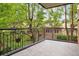 Balcony featuring metal railings and verdant tree view at 2400 E Cherry Creek South Dr # 207, Denver, CO 80209