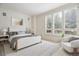 A cozy bedroom with neutral tones, white walls, and white-framed windows with shutter blinds at 2400 E Cherry Creek South Dr # 207, Denver, CO 80209