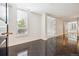 Condo foyer with black tile floors, a large window with shutters, and an open doorway to the rest of the home at 2400 E Cherry Creek South Dr # 207, Denver, CO 80209