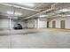Spacious parking garage with overhead lighting, ample parking, and concrete flooring at 2400 E Cherry Creek South Dr # 207, Denver, CO 80209