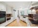 Eat-in kitchen featuring custom white cabinets, granite countertops, stainless steel appliances, and hardwood flooring at 2400 E Cherry Creek South Dr # 207, Denver, CO 80209