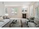 Bright living room features a decorative fireplace, light-colored walls, and comfortable seating arrangement at 2400 E Cherry Creek South Dr # 207, Denver, CO 80209