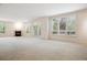 Open-concept living room with large windows, a fireplace, and neutral tones offers a bright and airy feel at 2400 E Cherry Creek South Dr # 207, Denver, CO 80209