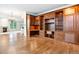 Bright living room features custom built-in shelving, desk, and hardwood floors at 2400 E Cherry Creek South Dr # 207, Denver, CO 80209