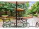 Charming patio with an umbrella-shaded table and garden view at 2400 E Cherry Creek South Dr # 207, Denver, CO 80209