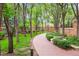 Scenic brick walkway winds through a lush, landscaped garden at 2400 E Cherry Creek South Dr # 207, Denver, CO 80209