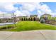 Large backyard with a well-manicured lawn, trampoline, trees, and fencing at 4884 St Vrain Rd, Firestone, CO 80504