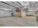 Unfinished basement with white walls, open ceiling, concrete floor, and visible utilities at 4884 St Vrain Rd, Firestone, CO 80504