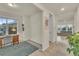 Inviting home office with wood desk, cozy rug and views into the living room at 4884 St Vrain Rd, Firestone, CO 80504