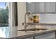 Close-up of kitchen island featuring granite countertop and modern faucet at 4884 St Vrain Rd, Firestone, CO 80504