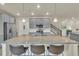 Spacious kitchen island with granite countertops, pendant lighting and breakfast bar at 4884 St Vrain Rd, Firestone, CO 80504