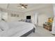 Main bedroom with a neutral color scheme, and tray ceiling, plus ensuite bathroom and a sitting area at 4884 St Vrain Rd, Firestone, CO 80504