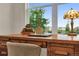 Well-lit home office with wood desk, ample natural light and neighborhood view at 4884 St Vrain Rd, Firestone, CO 80504