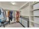 Walk-in closet with ample storage space, built-in shelving, drawers and a bench at 4884 St Vrain Rd, Firestone, CO 80504