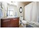 The bathroom features a granite countertop, matching cabinets, mirror, sink, toilet, and shower at 2447 Fairway Wood Cir, Castle Rock, CO 80109