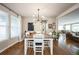 Charming dining room featuring hardwood floors, stylish light fixture, and open layout at 2447 Fairway Wood Cir, Castle Rock, CO 80109