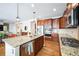 Well-equipped kitchen with granite countertops, stainless steel appliances, and an island at 2447 Fairway Wood Cir, Castle Rock, CO 80109