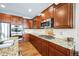 Kitchen with stainless steel appliances, granite countertops, and custom cabinets at 2447 Fairway Wood Cir, Castle Rock, CO 80109