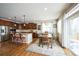 Open-concept kitchen and dining area with wood cabinets, island, and stainless steel appliances at 2447 Fairway Wood Cir, Castle Rock, CO 80109