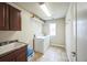 Bright laundry room with sink, washer, dryer, overhead storage, and window at 2447 Fairway Wood Cir, Castle Rock, CO 80109