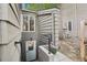 A private basement entry features a secure door, window and handrail access at 1582 W Briarwood Ave, Littleton, CO 80120