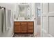 Bright bathroom features wooden vanity, modern mirror and ample counter space at 1582 W Briarwood Ave, Littleton, CO 80120