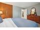 Comfortable bedroom features a wood dresser and a glimpse into an adjoining room at 1582 W Briarwood Ave, Littleton, CO 80120